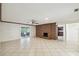 Bright living room with a brick fireplace, tile floors, and sliding doors to the outdoor porch at 207 S Sweetwater Blvd, Longwood, FL 32779