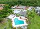 Aerial view of community amenities featuring a swimming pool, tennis court, clubhouse and lush landscaping at 208 Scottsdale Sq # 208, Winter Park, FL 32792