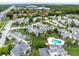 Aerial view of the community featuring apartments, pools, mature trees, landscaping, parking and roadways at 208 Scottsdale Sq # 208, Winter Park, FL 32792