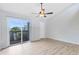 Laminate flooring, sliding glass doors to balcony, and a ceiling fan are featured in this bedroom at 208 Scottsdale Sq # 208, Winter Park, FL 32792
