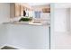 Bright kitchen with wood cabinets, white appliances, and modern design elements at 208 Scottsdale Sq # 208, Winter Park, FL 32792