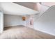 Spacious living room with modern flooring, high ceilings, and adjacent kitchen area at 208 Scottsdale Sq # 208, Winter Park, FL 32792