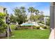 Beautiful community pool area with well-manicured lawn, landscaping and mature trees creating a private retreat at 208 Scottsdale Sq # 208, Winter Park, FL 32792