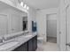 Elegant bathroom with double sinks, granite countertops, and a walk-in closet at 232 Summerlin Loop, Haines City, FL 33844