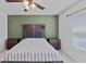 Comfortable bedroom featuring wood accents, a large bed, and plenty of natural light at 232 Summerlin Loop, Haines City, FL 33844