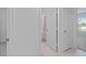 Hallway featuring tile flooring, access to a bathroom, and an adjacent bedroom at 232 Summerlin Loop, Haines City, FL 33844