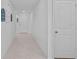 Neutral hallway with tile flooring, decorative wall art, and access to other rooms at 232 Summerlin Loop, Haines City, FL 33844