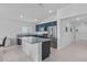 Open-concept kitchen with a center island, stainless steel appliances, and blue cabinets at 232 Summerlin Loop, Haines City, FL 33844