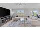 Comfortable living room features a large sectional sofa, modern entertainment center, and plenty of natural light at 232 Summerlin Loop, Haines City, FL 33844