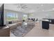 Open living space with sectional sofa, dining area, modern fixtures, and tile flooring at 232 Summerlin Loop, Haines City, FL 33844