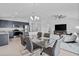Bright open-concept living and dining area featuring tile flooring, modern decor and stainless appliances at 232 Summerlin Loop, Haines City, FL 33844