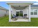Covered patio area with comfortable seating and a grill, ideal for outdoor dining at 232 Summerlin Loop, Haines City, FL 33844