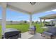 Cozy covered patio with rocking chairs overlooking the expansive backyard at 232 Summerlin Loop, Haines City, FL 33844