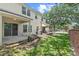 View of the backyard with a brick wall and covered patio area at 232 Windflower Way, Oviedo, FL 32765