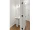 Powder room featuring a pedestal sink, stylish light fixture, and tile flooring at 232 Windflower Way, Oviedo, FL 32765