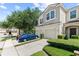 Well-maintained townhouse complex showcasing garages, manicured landscaping, and visible unit numbers at 232 Windflower Way, Oviedo, FL 32765