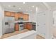Bright kitchen with stainless steel appliances, tile flooring, and wooden cabinetry at 232 Windflower Way, Oviedo, FL 32765