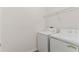 This laundry room features a washer and dryer and storage shelf at 232 Windflower Way, Oviedo, FL 32765