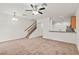 Bright living room featuring neutral carpet, staircase, and open layout at 232 Windflower Way, Oviedo, FL 32765