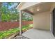 Covered patio space with views of the backyard and brick wall at 232 Windflower Way, Oviedo, FL 32765