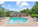Community pool with lounge chairs and tables for residents to enjoy at 232 Windflower Way, Oviedo, FL 32765
