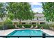 Refreshing community pool surrounded by lounge chairs and lush greenery for relaxation at 232 Windflower Way, Oviedo, FL 32765