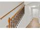 Carpeted staircase featuring decorative wrought iron spindles and wooden handrail at 232 Windflower Way, Oviedo, FL 32765