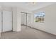 Neutral bedroom featuring a closet, a door and large window at 2404 Sw 20Th Ter, Ocala, FL 34471