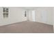 Bright, carpeted bedroom with window and access to a door at 2404 Sw 20Th Ter, Ocala, FL 34471
