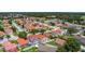 Charming aerial view showcasing a neighborhood with well-maintained homes and lush landscaping and screened in pools at 2422 Condado Ct, Kissimmee, FL 34743