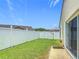 Fenced-in backyard featuring healthy green grass and a concrete patio at 2422 Condado Ct, Kissimmee, FL 34743