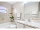 Well-lit bathroom with tub and shower, bright white vanity and ample counter space at 2422 Condado Ct, Kissimmee, FL 34743