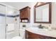 This bathroom features a glass shower, dark wood cabinet, and a mirror at 2422 Condado Ct, Kissimmee, FL 34743