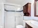 This bathroom features a glass shower, dark wood cabinet, and a mirror at 2422 Condado Ct, Kissimmee, FL 34743