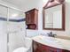 This bathroom features a glass shower, dark wood cabinet, and a mirror at 2422 Condado Ct, Kissimmee, FL 34743