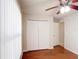 Bright bedroom features a hardwood floor, a ceiling fan, and a window with blinds at 2422 Condado Ct, Kissimmee, FL 34743
