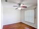Bedroom featuring wood floors, neutral paint, a ceiling fan, and a window with blinds at 2422 Condado Ct, Kissimmee, FL 34743