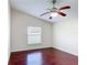 This bedroom features a ceiling fan, wood floors, a window with blinds and neutral paint at 2422 Condado Ct, Kissimmee, FL 34743