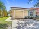 Charming single-story home featuring a terra cotta roof, and an attached garage at 2422 Condado Ct, Kissimmee, FL 34743
