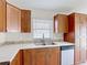 A bright kitchen features wooden cabinets, white countertops with a tile backsplash, and stainless steel appliances at 2422 Condado Ct, Kissimmee, FL 34743