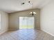 Open-concept living area with tile flooring, vaulted ceilings and natural light from sliding glass doors at 2422 Condado Ct, Kissimmee, FL 34743