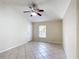 Bright living room featuring a ceiling fan, window, and neutral-toned tile flooring at 2422 Condado Ct, Kissimmee, FL 34743