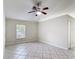 Bright living room featuring a ceiling fan, window, and neutral-toned tile flooring at 2422 Condado Ct, Kissimmee, FL 34743