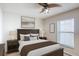 Comfortable bedroom with a ceiling fan, wood furnishings, and a plush queen-size bed at 2422 Condado Ct, Kissimmee, FL 34743
