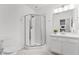 Well-lit bathroom with a glass-enclosed shower, modern fixtures, and white vanity at 2432 Riviera Ln, Minneola, FL 34715
