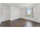 Bedroom features a window with printed curtains, a closet and wood-look flooring at 2432 Riviera Ln, Minneola, FL 34715