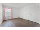 Bright bedroom features a large window with stylish pink curtains and hardwood floors at 2432 Riviera Ln, Minneola, FL 34715