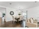 An open dining and living area features a decorative mirror, six chairs, and stylish modern furniture at 2432 Riviera Ln, Minneola, FL 34715