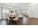 Bright dining area boasts hardwood floors, a large window, and an open floorplan leading to the living room at 2432 Riviera Ln, Minneola, FL 34715