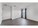 Clean, empty room with dark wood floors, one window, and a closet, ready for customization at 2432 Riviera Ln, Minneola, FL 34715